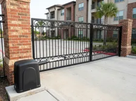 Entrance gates of an apartment building with a gate opener beside them