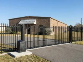 Slide gate and gate opener at the yard entrance of a small business