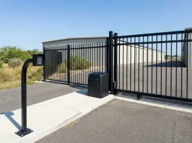 Gate opener, slide gate and keypad at the entrance of a storage facility