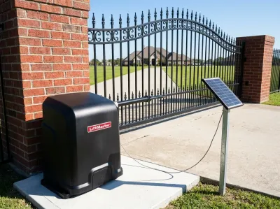 Black LiftMaster gate opener with a solar panel on a post, beside a wrought-iron driveway gate